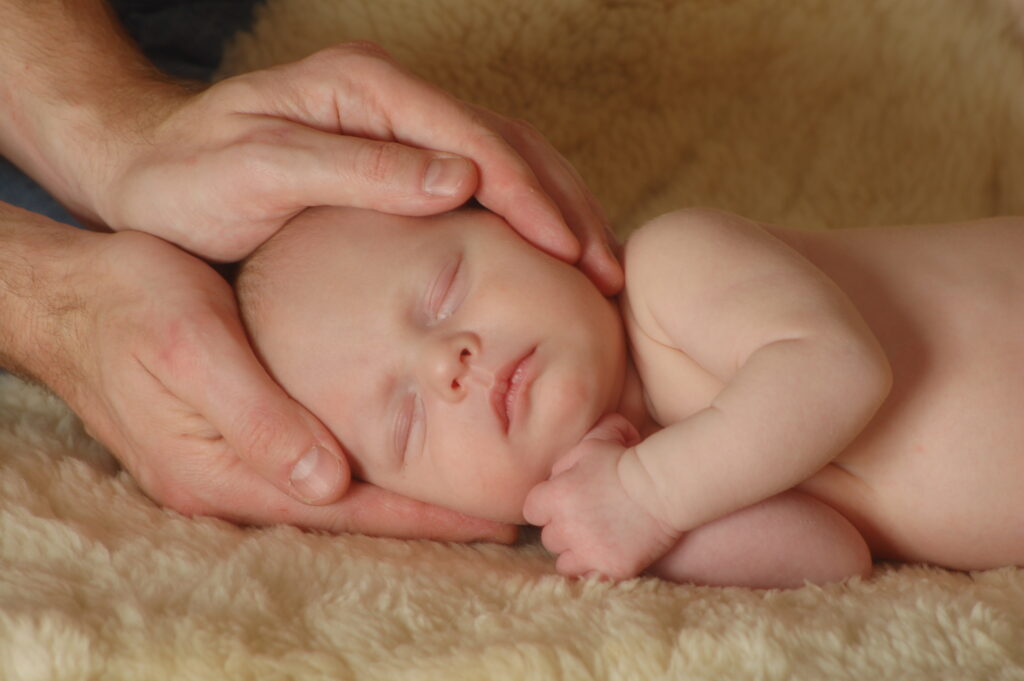 Image showing a baby receiving reiki treatment