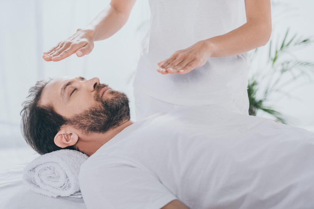 Image of a man receiving reiki treatment